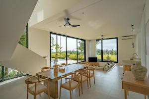 an open living room with a table and chairs at Sealuna Villas in Tanah Lot