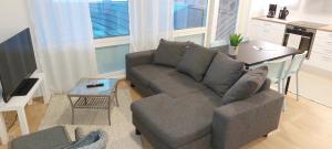 a living room with a couch and a table at Apartment Kauppatie, neljälle hengelle in Laihia