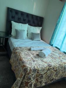 a bed with two towels on top of it at Moon Memories Guesthouse in Welkom