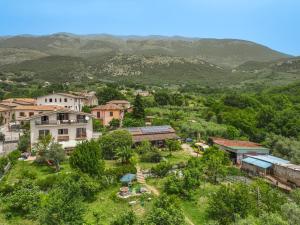 an aerial view of a village with mountains in the background at Italyfarmstay in Pescosolido