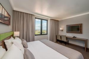 Cama ou camas em um quarto em Linx Confins