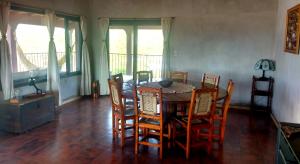 a dining room with a wooden table and chairs at Habitación privada en casa rural, vistas Uritorco in Capilla del Monte