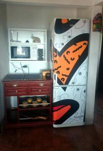 a kitchen with a refrigerator and a microwave at Habitación privada en casa rural, vistas Uritorco in Capilla del Monte