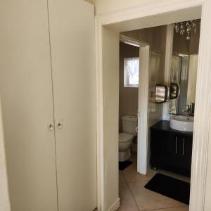 a bathroom with a toilet and a sink at Casa Angelo in Vanderbijlpark +27 photos