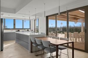 Una cocina y un comedor con mesa y sillas. en Serenity Waves Villa 5, en Lárnaca