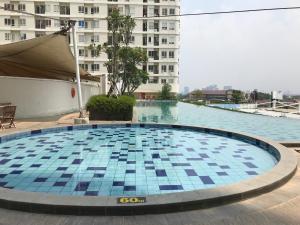 a swimming pool on the roof of a building at Warm and Cozy Studio at Cinere Bellevue Suites Apartment By Travelio in Depok