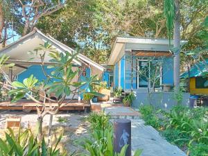 a blue house with trees in front of it at Seasonsamed Resort in Ao Phutsa