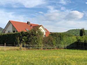 a house with a fence in a field at Ferien - Apartment umgeben von Obstplantagen in Waldkirch