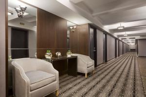 a hallway with two chairs and a table and a mirror at Hotel Edison Times Square in New York
