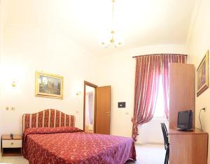 a bedroom with a red bed and a window at Hotel Euro Quiris in Rome