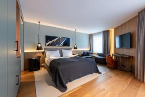 a hotel room with a bed and a couch at Hotel Rosatsch in Pontresina +203 photos