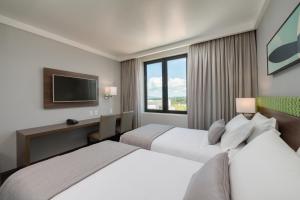 Cama ou camas em um quarto em Linx Confins