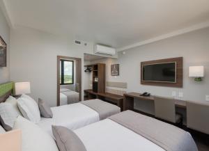 Cama ou camas em um quarto em Linx Confins