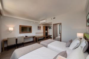 Cama ou camas em um quarto em Linx Confins