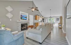 a living room with two couches and a fireplace at Whiskey River Lake Retreat in Taylorsville