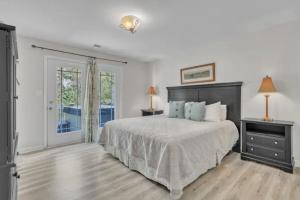 a white bedroom with a bed and a window at Whiskey River Lake Retreat in Taylorsville +32 photos
