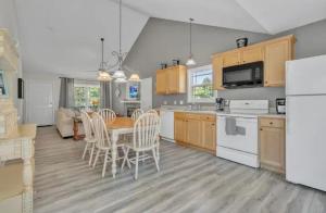 a kitchen and dining room with a table and chairs at Whiskey River Lake Retreat in Taylorsville