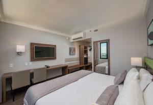 Cama ou camas em um quarto em Linx Confins