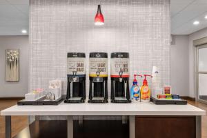 a counter with a bunch of alcohol bottles on it at Hampton Inn Atlanta McDonough in McDonough