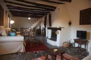 a living room with a couch and a fireplace at Casa Josefa in Capileira