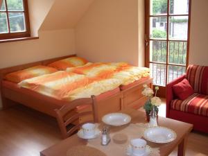 a small bedroom with a bed and a table at Pension a Restaurace Vyhlídka in Karlštejn