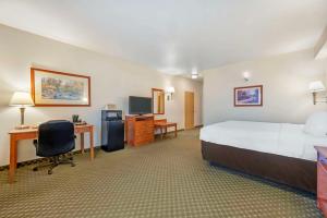 a large hotel room with a bed and a desk at Comfort Inn & Suites Rawlins in Rawlins +24 photos
