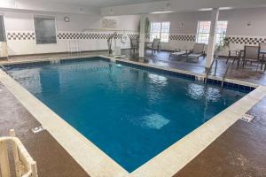a large swimming pool with blue water in a building at Country Inn & Suites by Radisson, Elgin, IL in Elgin