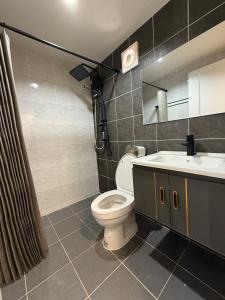 a bathroom with a toilet and a sink at D Glamor Hotel Phutthamonthon Sai 1 ,Southern Bus Terminal, Bangkok in Bangkok