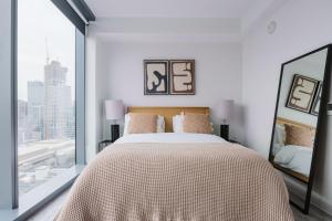 a bedroom with a large bed and a large window at Blueground Downtown pool AC nr Capitol ATX-294 in Austin +36 photos