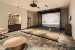 a living room with a large projection screen at Blueground Downtown pool AC nr Capitol ATX-294 in Austin