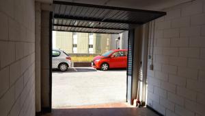 a hallway with two cars parked in a parking lot at Quarto di Luna in Genoa