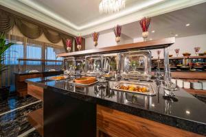 a buffet line with plates of food in a restaurant at Peony Palace Hotel in Kayseri