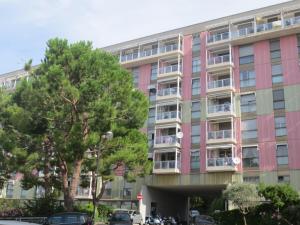 a pink building with cars parked in front of it at Quarto di Luna in Genoa