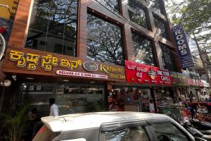 a building with signs on the side of a street at Krishna Stay Inn in Bengaluru +2 photos