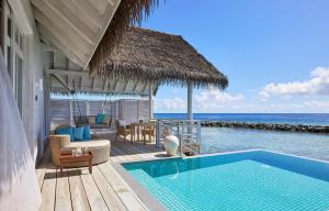 a house with a swimming pool next to the ocean at NH Maldives Kuda Rah Resort - Complimentary return Seaplane trip for stays of 7 nights until 22 December 2025 in Dhangethi +64 photos
