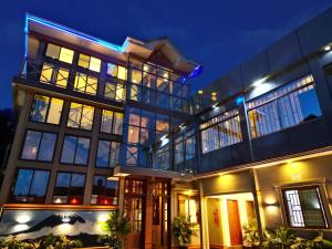 a large building with a lot of windows at night at River House Lodge International in Arusha