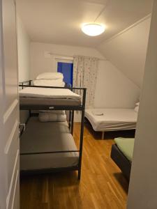 a small room with two bunk beds in it at FeelHome 4 bedrooms apartment Polarvegen in Tromsø