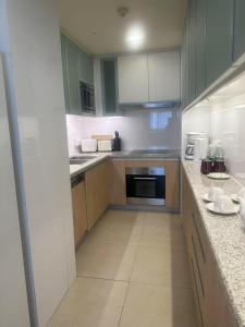 a large kitchen with wooden cabinets and appliances at Oakwood Residence Shanghai in Shanghai +45 photos