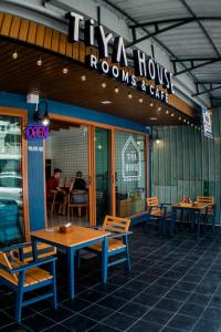 a restaurant with tables and chairs in front of it at Tiya House Rooms & Cafe in Krabi