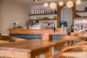 a restaurant with wooden tables and a counter top at Tiya House Rooms & Cafe in Krabi