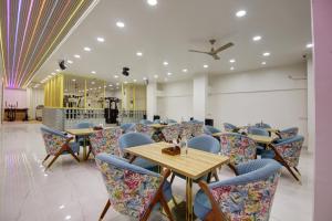 a restaurant with tables and chairs in a room at Miyabi suites in Gurgaon