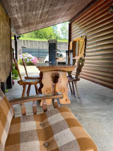a wooden table with a laptop sitting on a patio at Chalet Aledia in Pessinetto