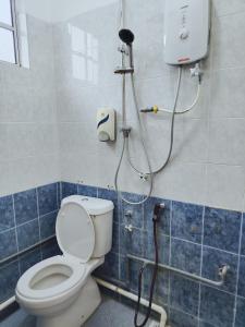 a bathroom with a toilet and a shower at Pearl Villa 5 Bedroom Unit 7 in Port Dickson