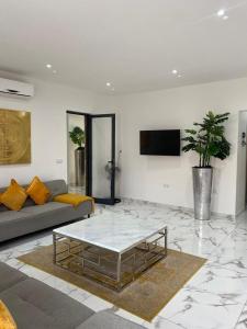 a living room with a couch and a coffee table at Beach House in Calhau