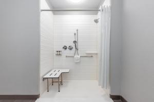 a bathroom with a bench and a shower at avid hotel Austin NW - Lakeline by IHG in Austin +39 photos