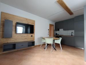 a kitchen and dining room with a table and chairs at Villa Emma in Ponte di Legno