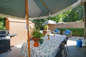 a table under an umbrella on a patio at KD 808 - Vakantiepark Kijkduin in The Hague
