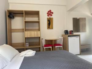 a bedroom with a bed and a kitchen with a counter at Cosy studio 2 in Stoupa in Stoupa