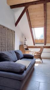 a living room with a couch and a chair at Ferienwohnung am alten Kino in Peißenberg