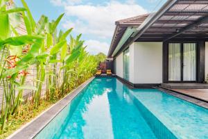 ein Swimmingpool vor einer Villa in der Unterkunft Javana Royal Villas in Seminyak